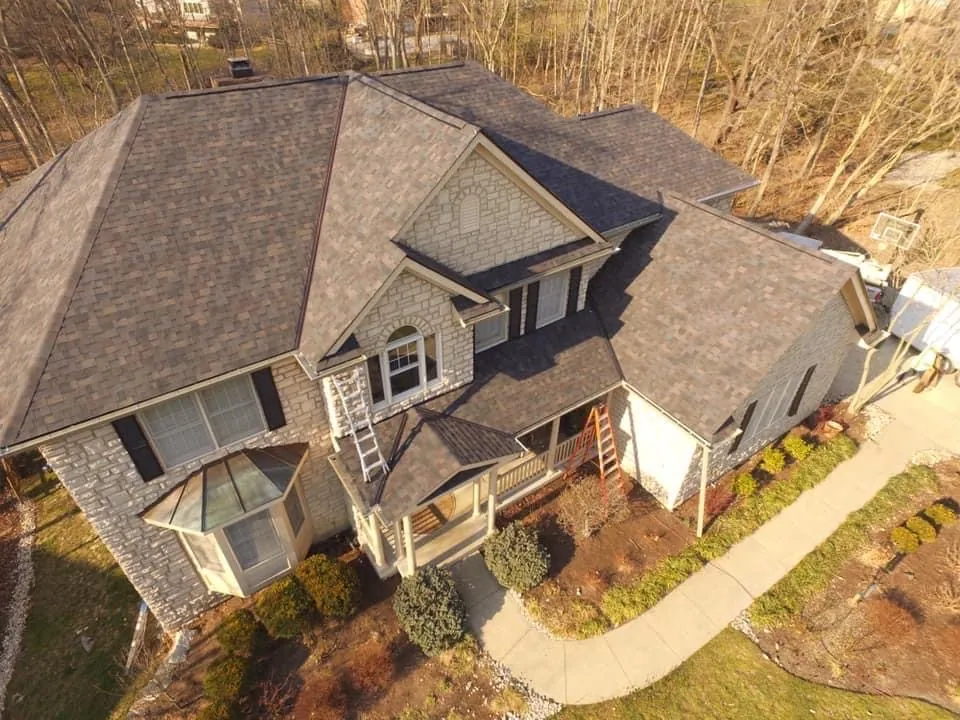 Brown shingle roof on a stone home