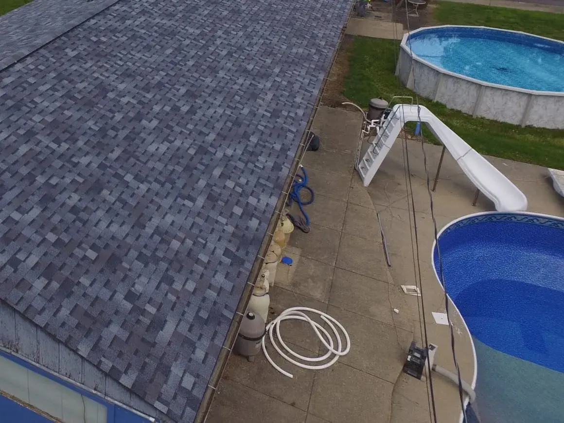 Finished blue shingle roof on a long single-story building