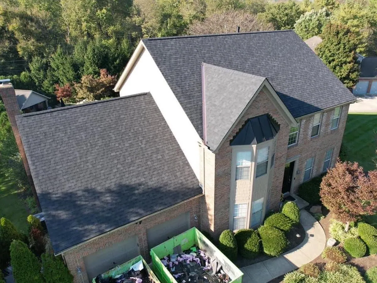 Finished dark shingle roof on a two-story brick home