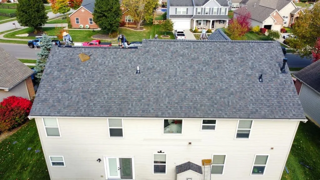 Finished gray shingle roof on a white two-story home
