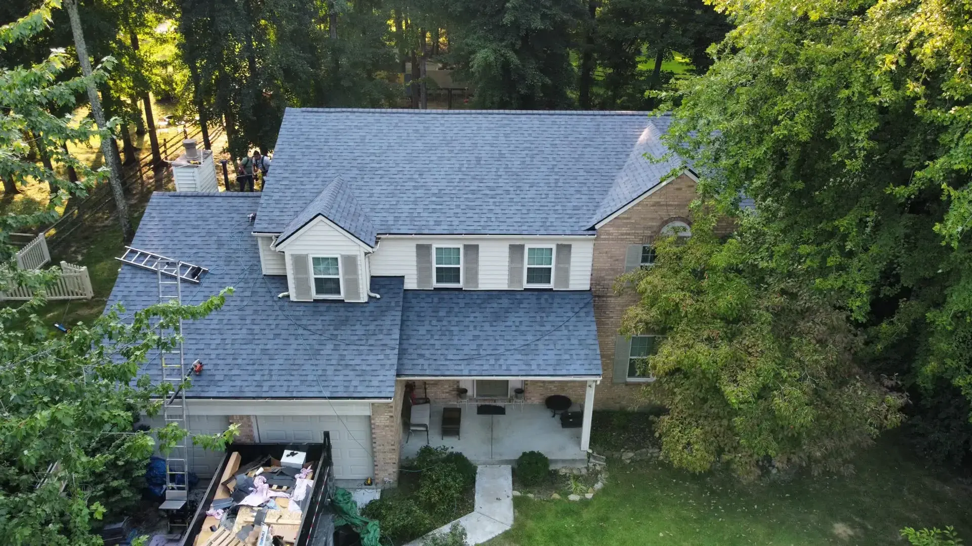 Drone photo of a home with a new shingle roof installed by SWORD Roofing