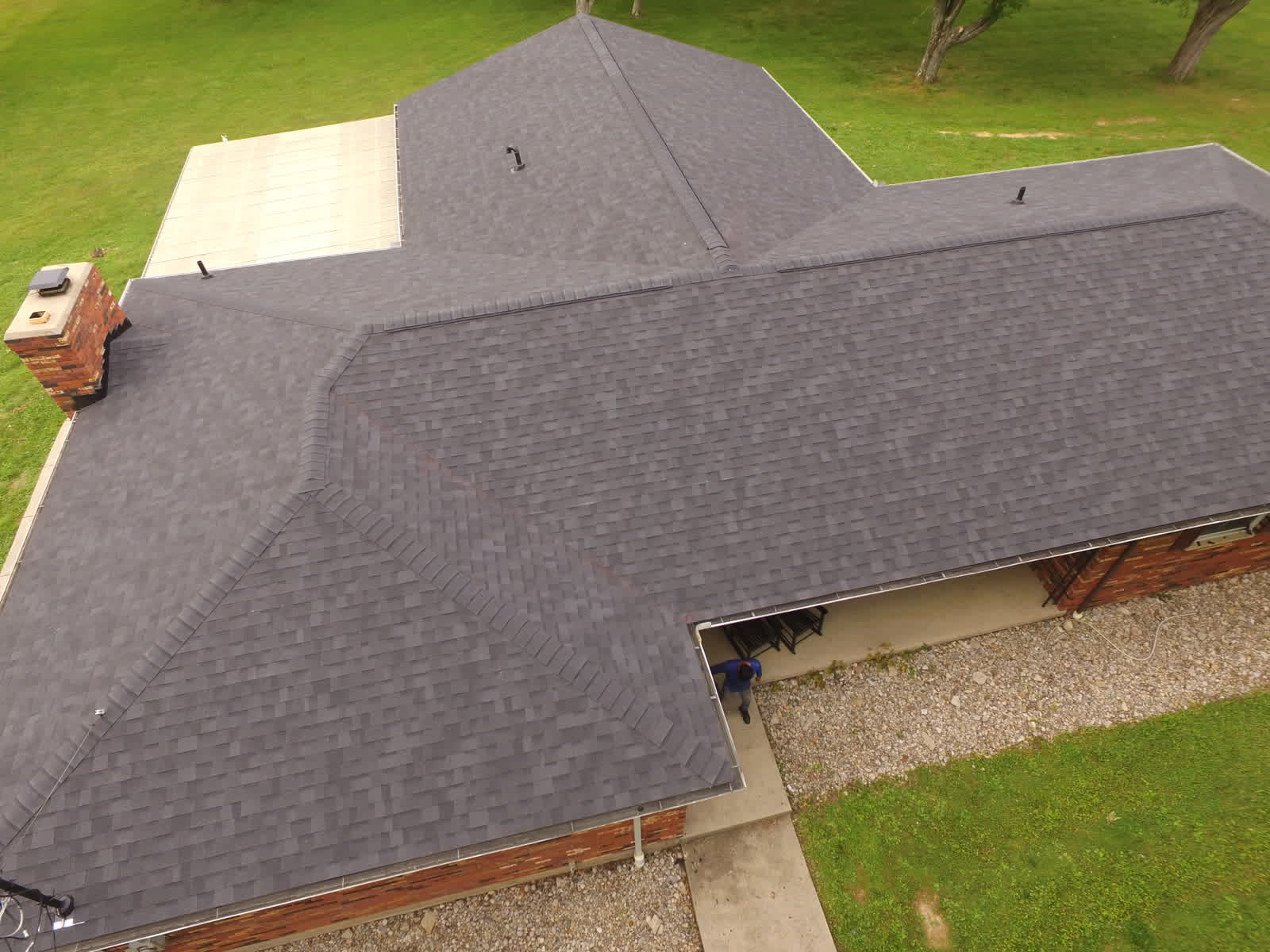 Close drone view of a new charcoal shingle roof