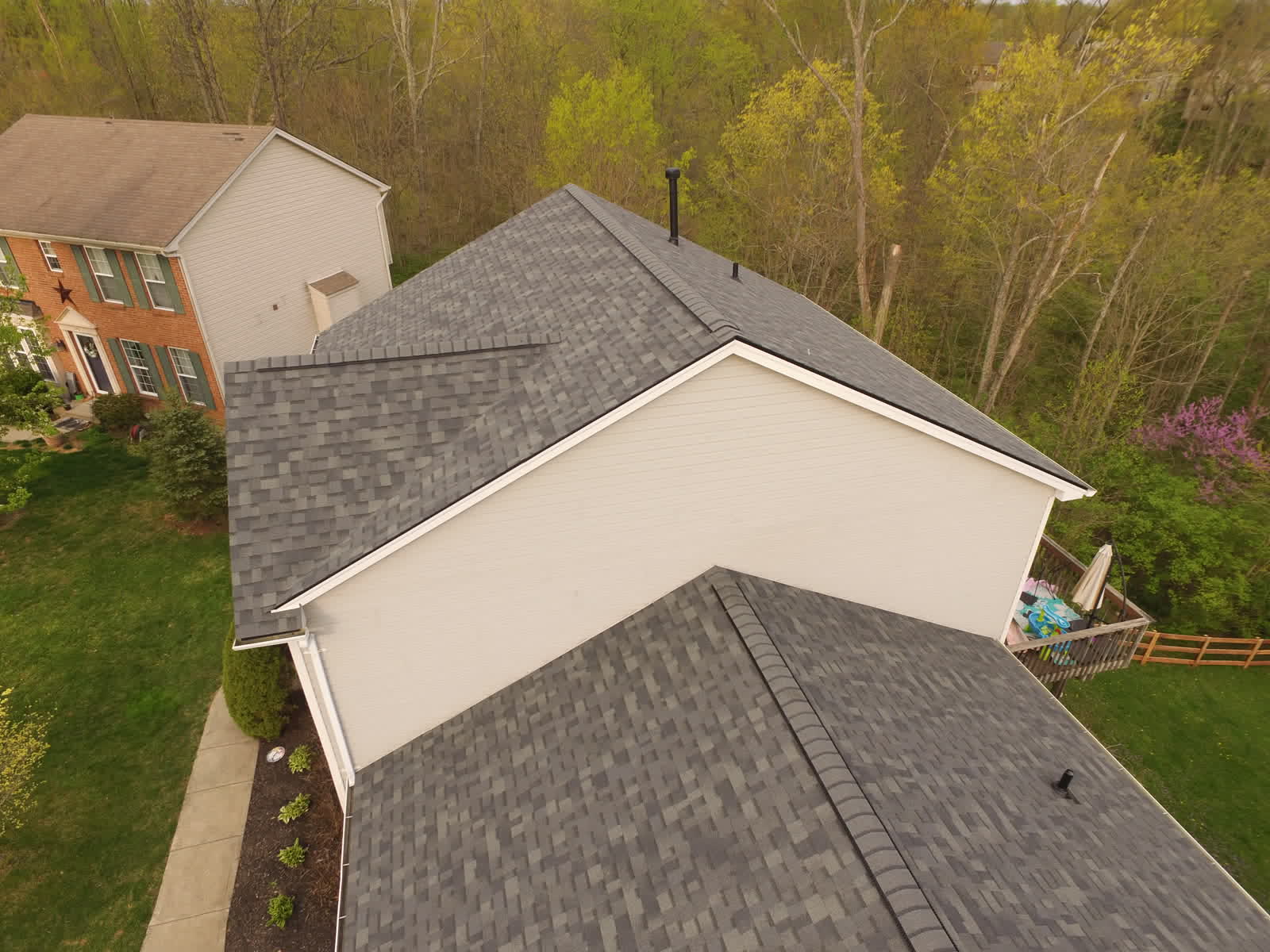 Drone photo of a new gray shingle roof seen from the side