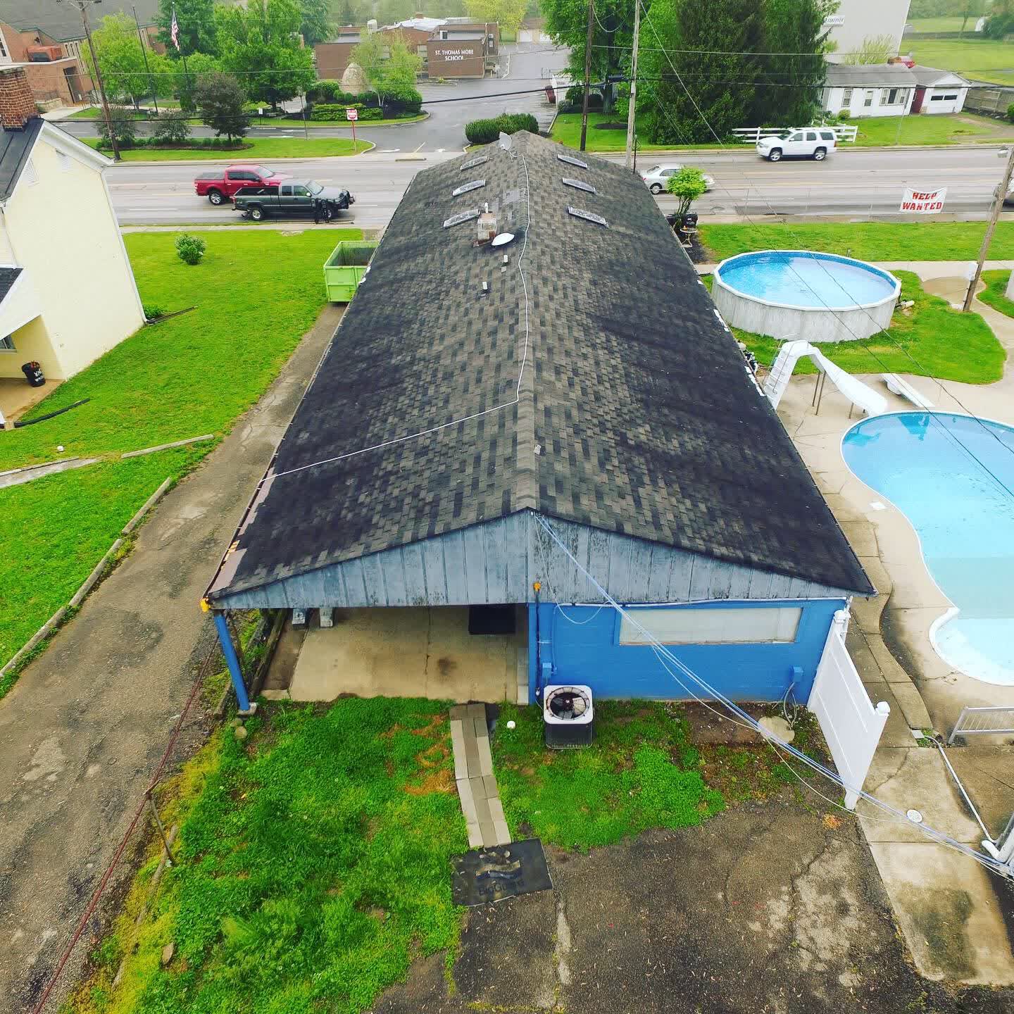 Drone photo of an old shingle roof on a long single-story building