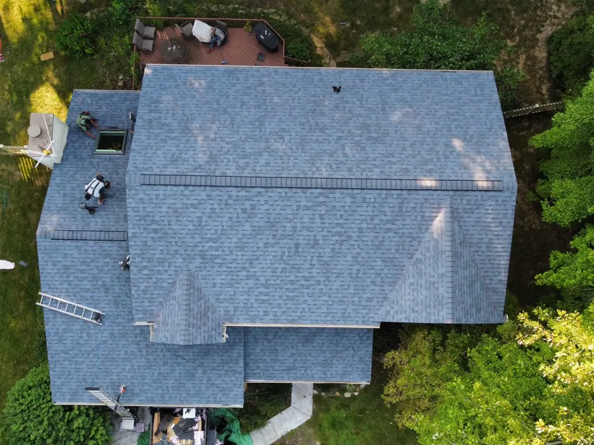 Overhead view of a finished blue-gray shingle roof