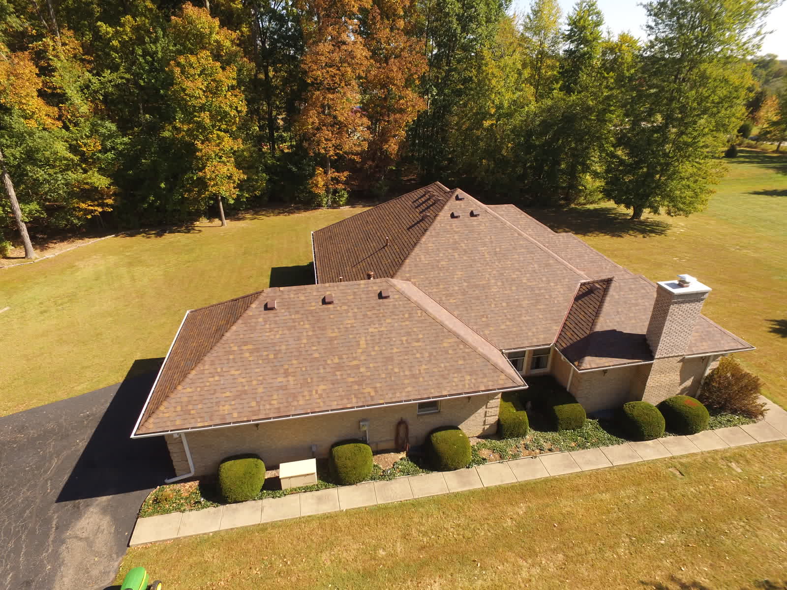 Drone photo of a ranch home with a new brown hip roof