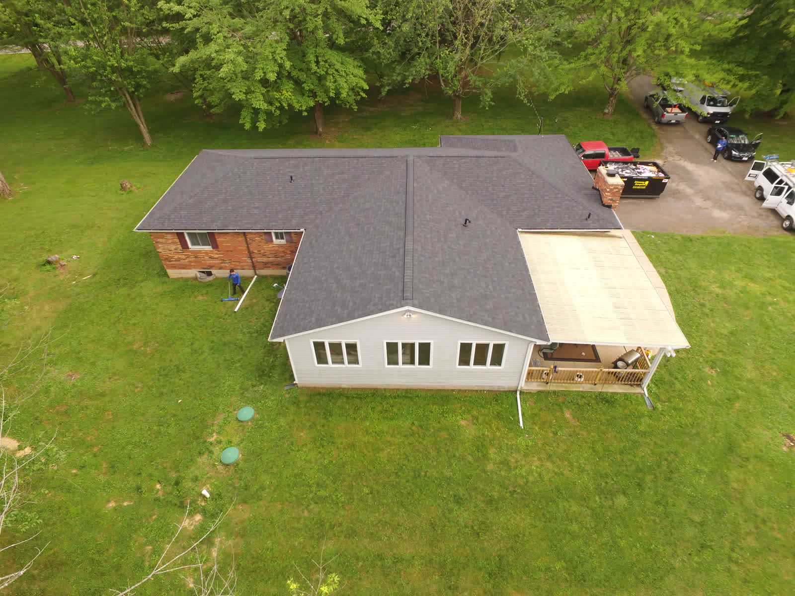 Drone photo of a ranch home with a new charcoal shingle roof