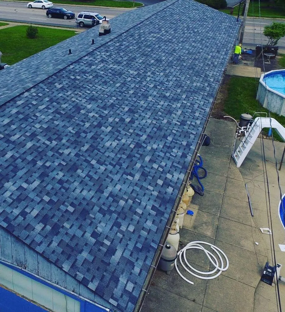 Drone photo along the ridge of a finished blue shingle roof