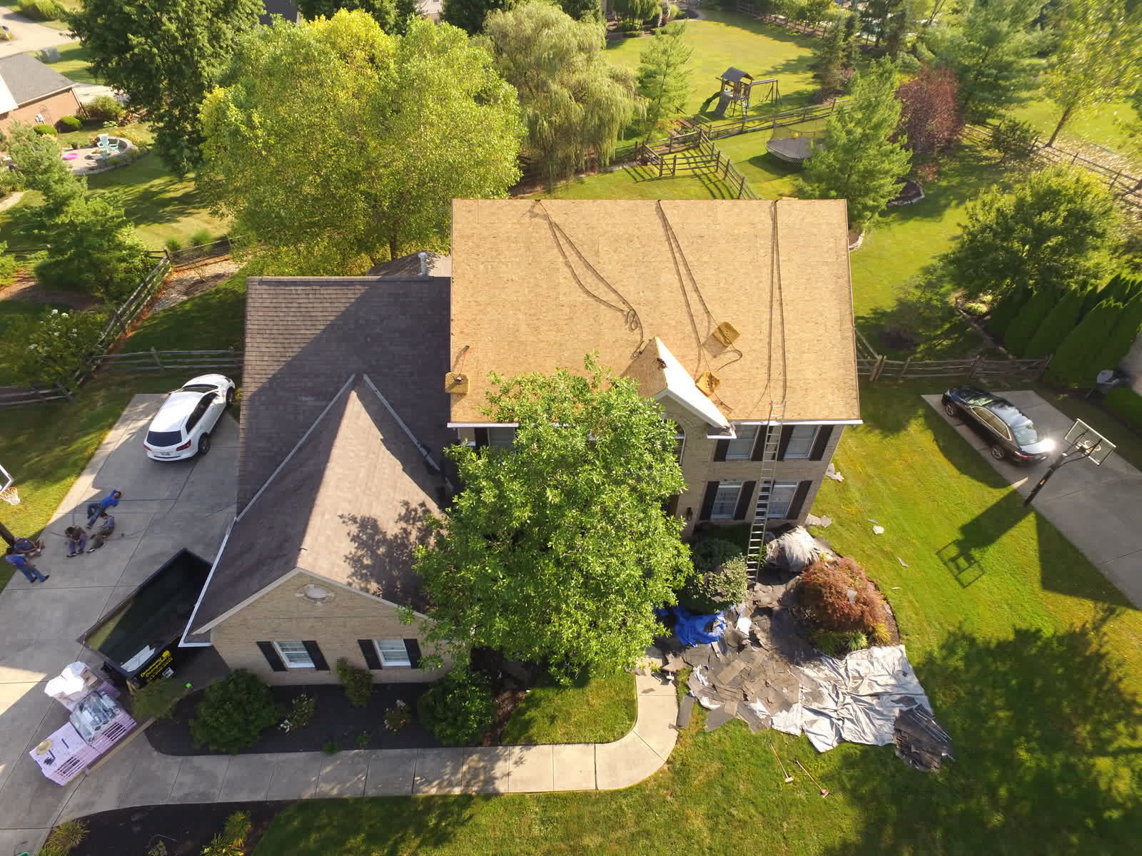 Drone photo of a roof replacement: decking exposed on a two-story home