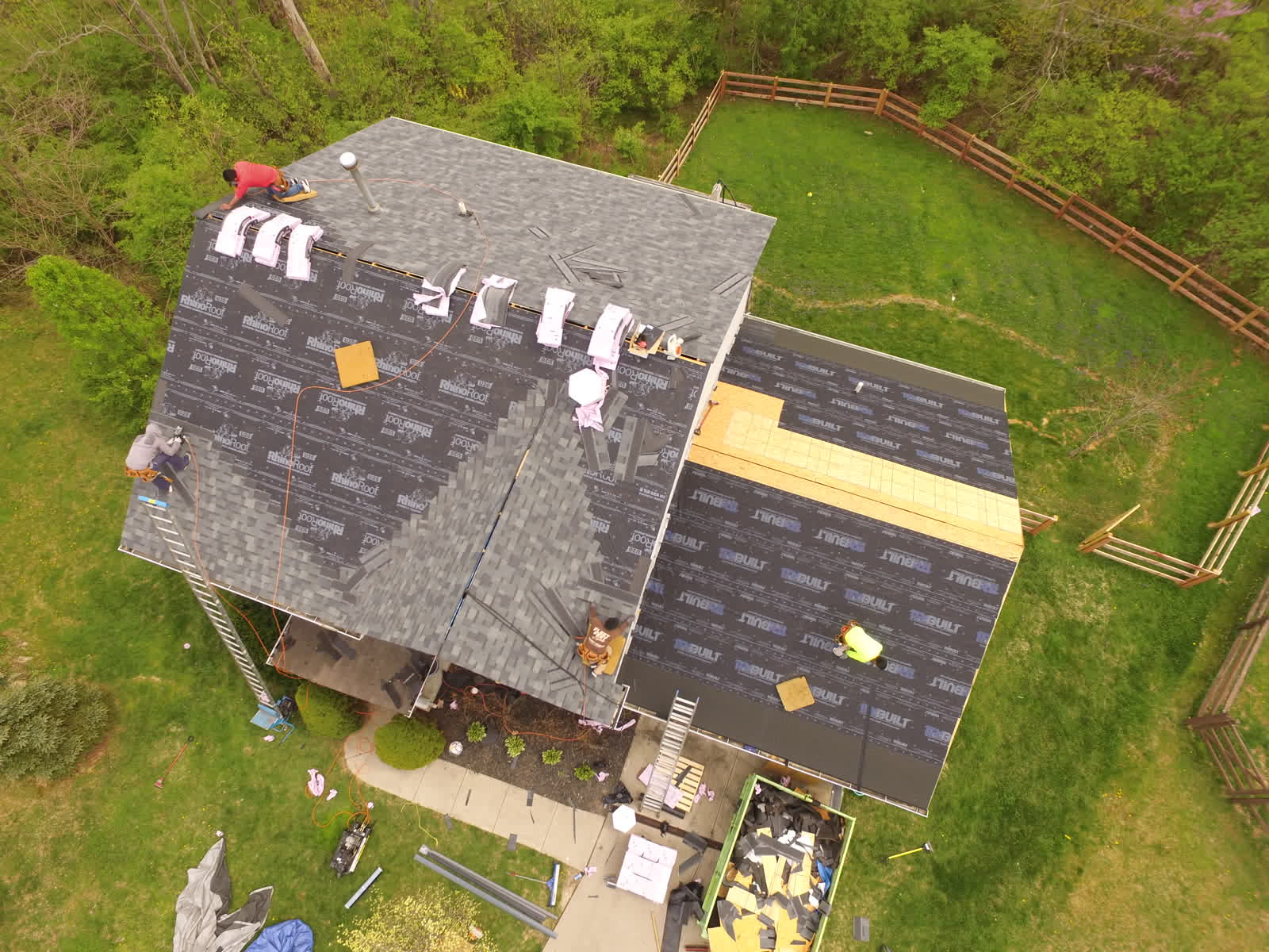 Drone photo of a roof replacement: new shingles going on a two-story home