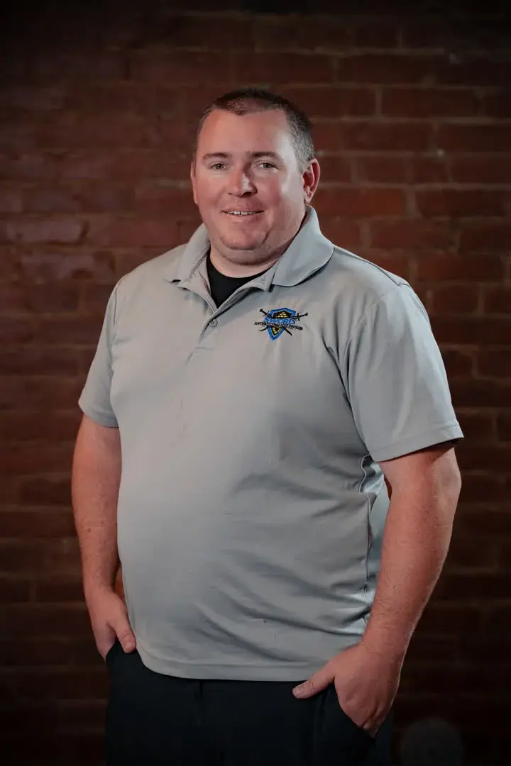 Johnny Dumford, general manager of SWORD Roofing, in a gray company polo