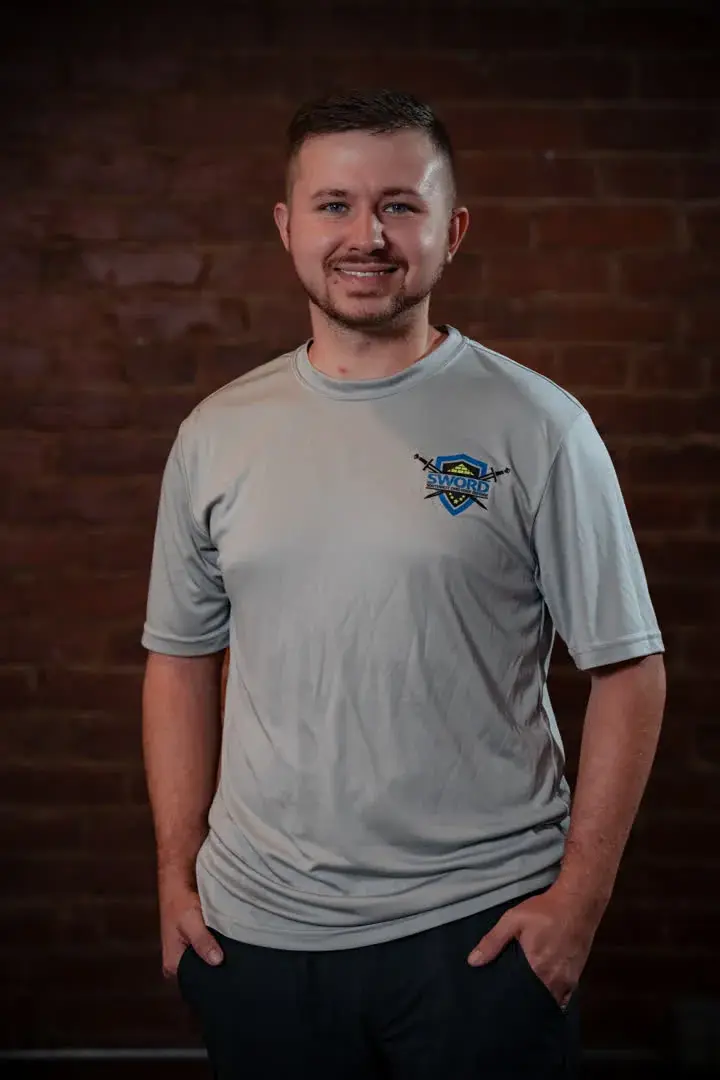 Curry Lykins, sales technician of SWORD Roofing, in a gray company shirt