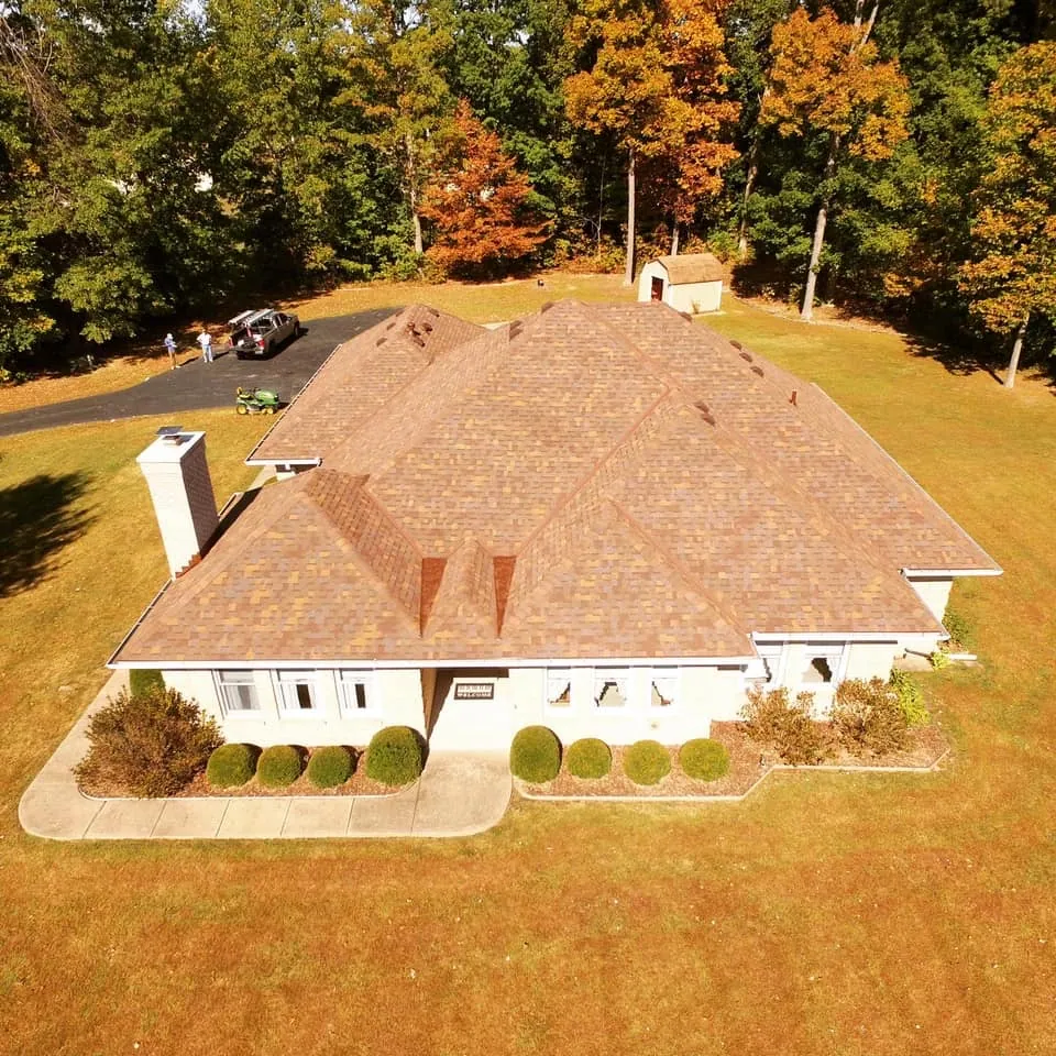 Tan shingle roof on a ranch home in autumn
