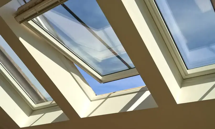 Open roof windows seen from inside against a blue sky