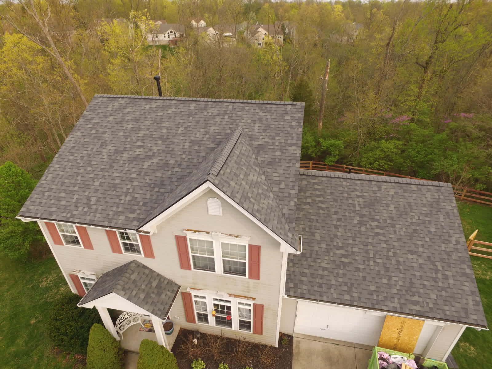 Drone photo of a two-story home with a new gray shingle roof