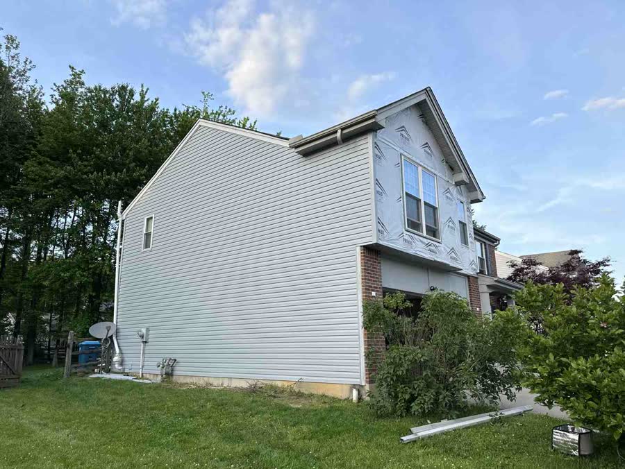 White vinyl siding on the side of a two-story home