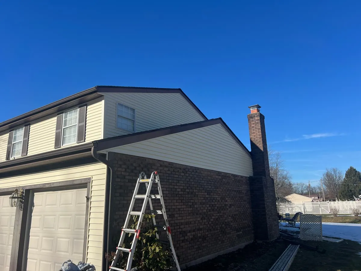 Vinyl siding and trim on the gable end of a two-story home